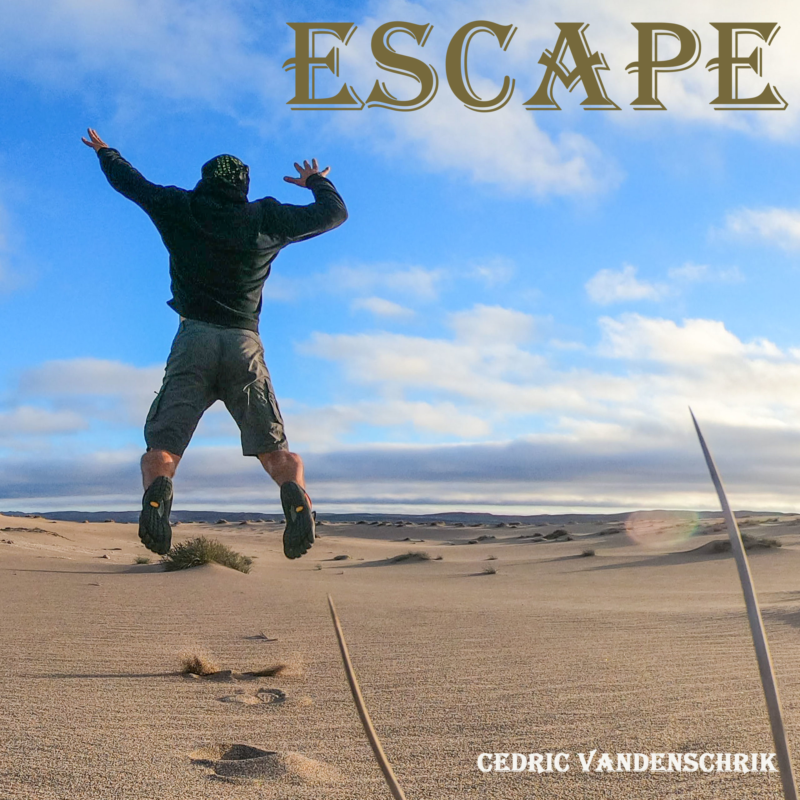 Man from back Jumping in Desert With Writing: ESCAPE Cedric Vandenschrik