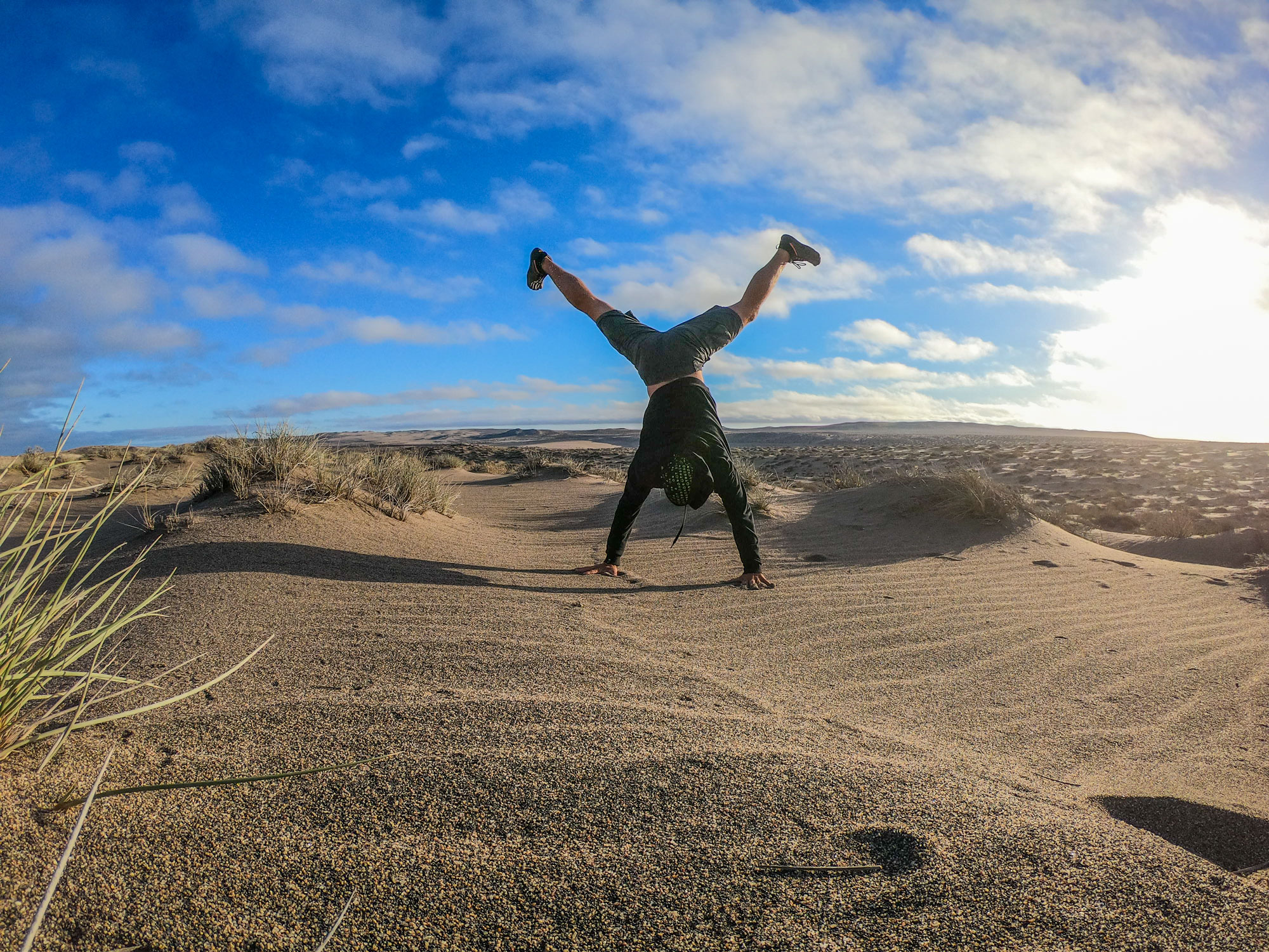 Man doing Handstand in desert